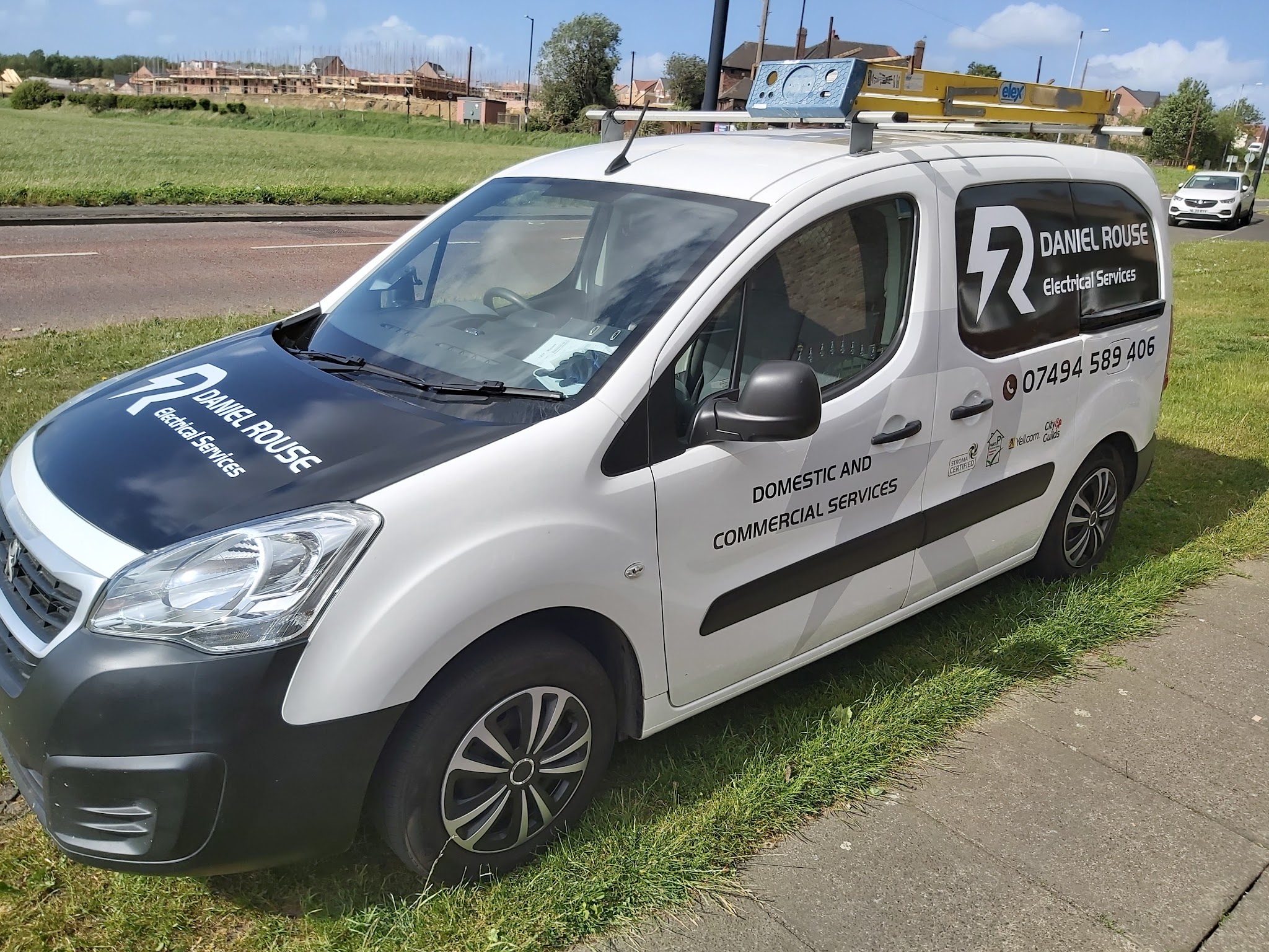 Daniel Rouse Electrical Services van, white with the lightning R logo and the phone number on the side