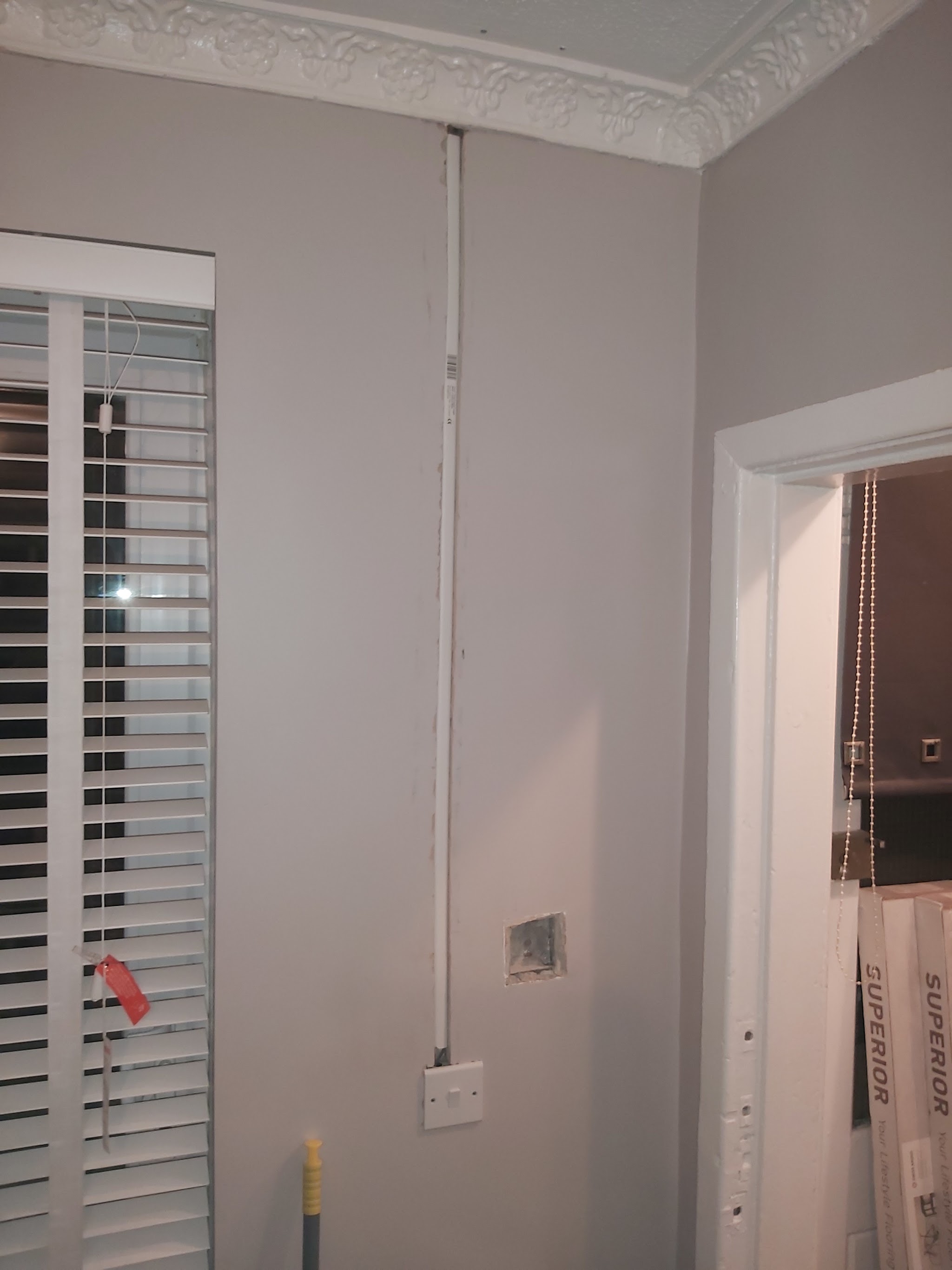 A new double socket and a neat cable run on a grey wall